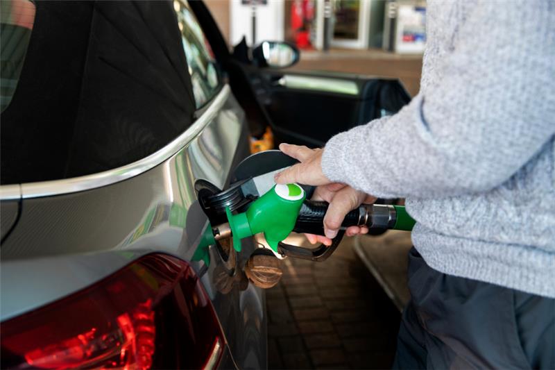 Photo of a person filling a car with fuel
