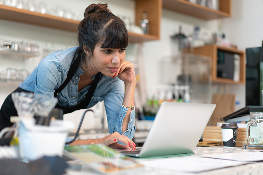 Female cafe owner on a laptop